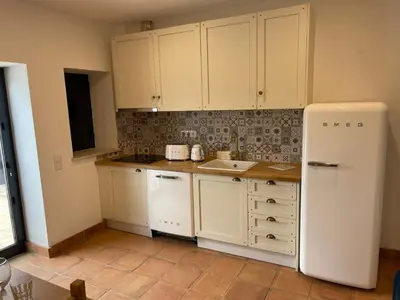 a kitchen with white cabinets and a white refrigerator at Monte Gerações - Heated pool - Typical Algarvian - close to Quinta Lago, Vale Lobo and Vilamoura in Almancil