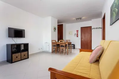 a living room with a couch and a dining room at Blife Amorya private apartment in Faro