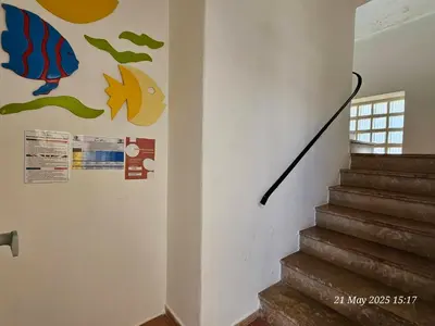 a staircase with a mural on the wall at Blife Ceriya private apartment in Faro