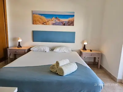 a bedroom with a bed with towels on it at Blife Ceriya private apartment in Faro