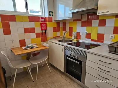 a small kitchen with a sink and a stove at Blife Ceriya private apartment in Faro