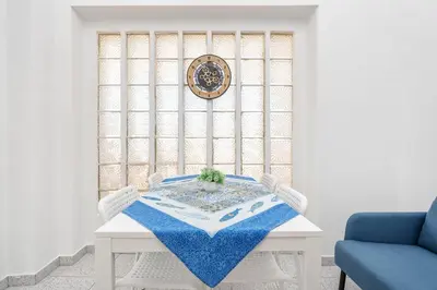a white table with a blue table cloth on it at Blife Riamya private apartment in Faro