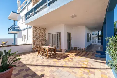 a patio with a table and chairs on a building at Blife Riamya private apartment in Faro