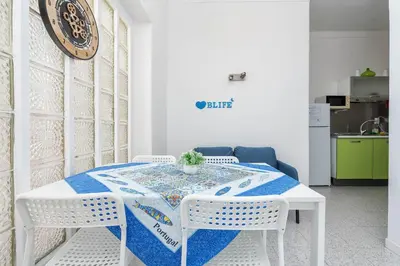 a white table with two white chairs and a blue table cloth at Blife Riamya private apartment in Faro