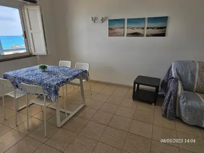 a dining room with a table and chairs with a view of the ocean at Blife Vistaya private apartment in Faro