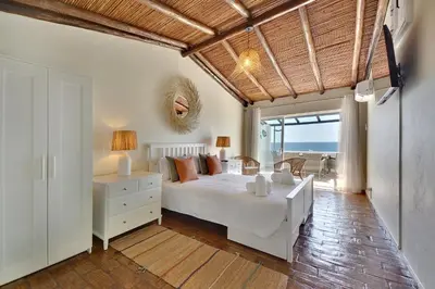 a bedroom with a white bed and a view of the ocean at Beach Residence Old Town in Albufeira