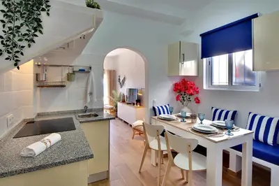 a kitchen and living room with a table and chairs at Beach Residence Old Town in Albufeira