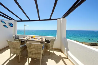 a dining room with a view of the ocean at Beach Residence Old Town in Albufeira