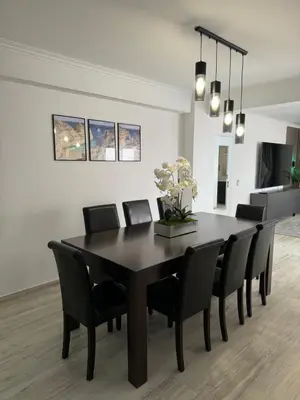 a dining room with a black table and chairs at Princess Retreat Beautiful Modern Aprt 2 min walk from Quarteira Beach in Quarteira