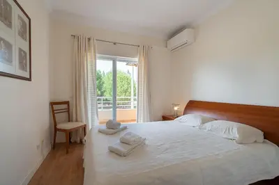 a bedroom with a bed with two towels on it at VILAMOURA Two Bedroom Near Praia Falésia in Quarteira