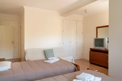 a bedroom with two beds and a tv at VILAMOURA Two Bedroom Near Praia Falésia in Quarteira