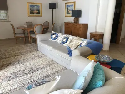 a house with a pool and a table and an umbrella at Santos Villa in Quinta do Lago in Quinta do Lago