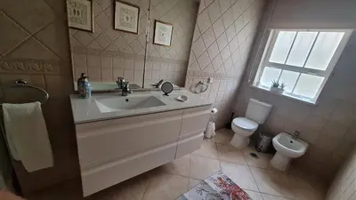 a bathroom with two sinks and a toilet at Santos Villa in Quinta do Lago in Quinta do Lago
