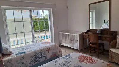 a white crib with a bed in a room at Santos Villa in Quinta do Lago in Quinta do Lago