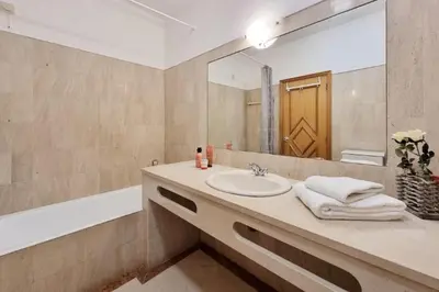 a bathroom with a sink and a mirror at Blue Palmtree in Albufeira