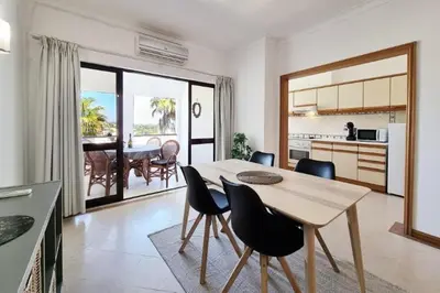 a kitchen and dining room with a table and chairs at Blue Palmtree in Albufeira