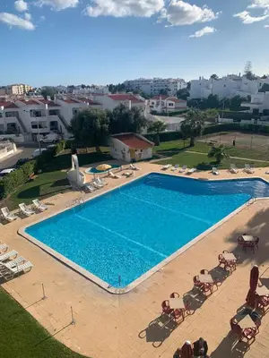 an overhead view of a large swimming pool with lounge chairs at S Soares T1 Sil Choro in Albufeira