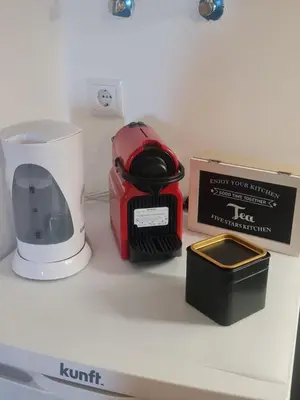 a counter with a toaster and a box on it at S Soares T1 Sil Choro in Albufeira