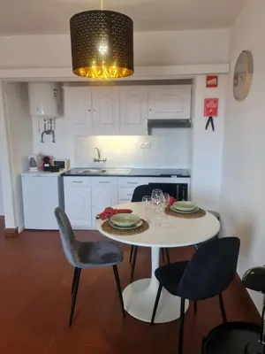 a kitchen with a white table and chairs at S Soares T1 Sil Choro in Albufeira