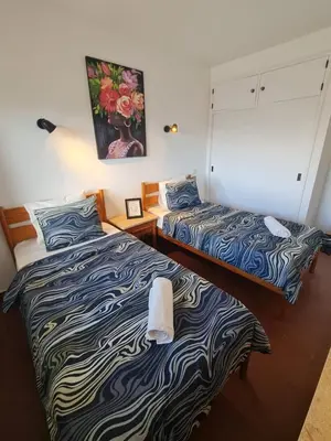 two beds sitting next to each other in a room at S Soares T1 Sil Choro in Albufeira