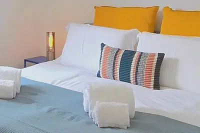 a large bed with white sheets and pillows at Segolene Design in Albufeira