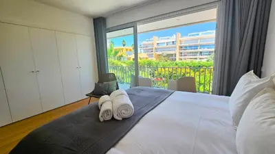 a bedroom with a bed with towels on it at Segolene Design in Albufeira