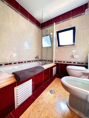 a bathroom with a tub and a toilet and a sink at Villa Sarah by BeCherish in Quarteira