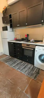 a kitchen with a sink and a washing machine at Grand Studio 56 in Faro
