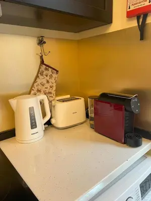 a kitchen counter with two toasters and a microwave at Grand Studio 56 in Faro