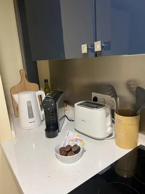 a kitchen counter with a toaster and a toaster and a bowl of cookies at Grand Studio 52 in Faro