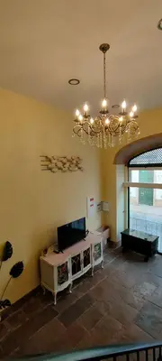 a living room with a chandelier and a table at Grand Studio 52 in Faro
