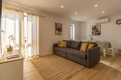 a living room with a couch and a table at Cosy apartment in Albufeira, OURA ST in Albufeira