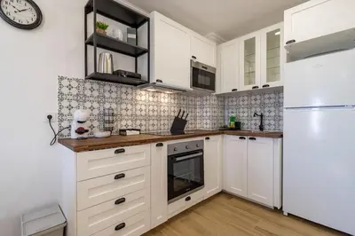 a kitchen with white cabinets and a white refrigerator at Cosy apartment in Albufeira, OURA ST in Albufeira