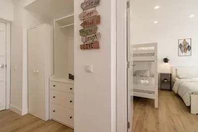 a bedroom with a bed and a dresser and a mirror at Cosy apartment in Albufeira, OURA ST in Albufeira