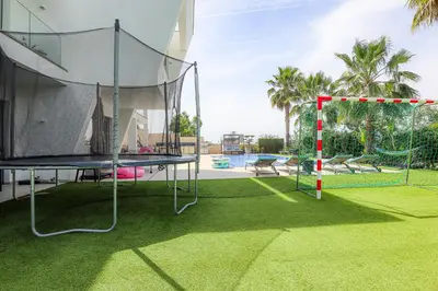 a villa with a swimming pool and flowers at Villa Moroz - BY BEDZY in Almancil