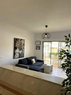 a living room with a couch and a table at Moradia Almorávia in Olhos de Água