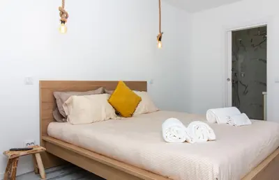 a bedroom with a bed with two towels on it at Amelie Old Town Apartment in Albufeira