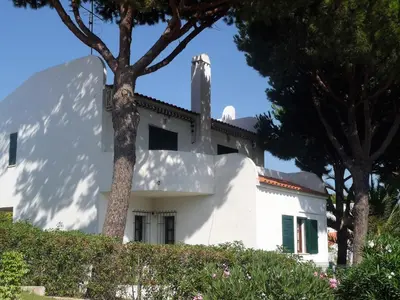 a white house with trees in front of it at VM Relax Beautiful villa with pool! VILAMOURA! in Quarteira