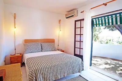 a bedroom with a bed and a window at VM Relax Beautiful villa with pool! VILAMOURA! in Quarteira