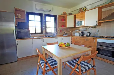 a kitchen with a table with a bowl of fruit on it at VM Relax Beautiful villa with pool! VILAMOURA! in Quarteira
