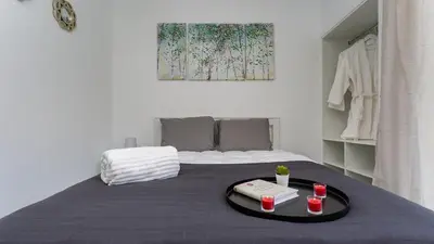 a room with a bed with a table with two cups on it at La Liberdad Loft in Albufeira