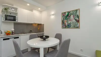 a kitchen with a white table and chairs at La Liberdad Loft in Albufeira