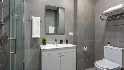 a bathroom with a toilet and a sink and a shower at La Liberdad Loft in Albufeira