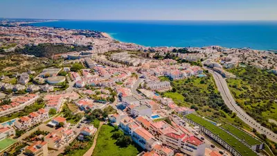 an aerial view of a city next to the ocean at Pateo Loft in Albufeira