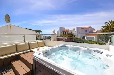 a hot tub on the roof of a balcony at Stunning 2-Bedroom Beach Retreat in Vale do Lobo in Almancil