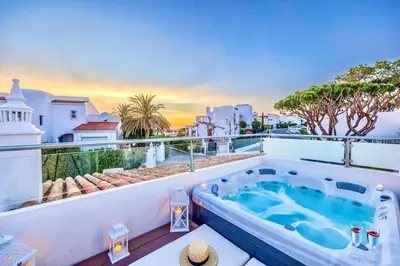 a hot tub on the balcony of a house at Stunning 2-Bedroom Beach Retreat in Vale do Lobo in Almancil