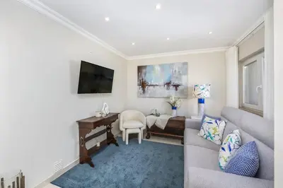 a living room with a couch and a desk at Stunning 2-Bedroom Beach Retreat in Vale do Lobo in Almancil
