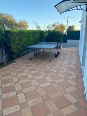 a ping pong table sitting on a patio at Villa Albufeira 1 à 6 personnes in Guia