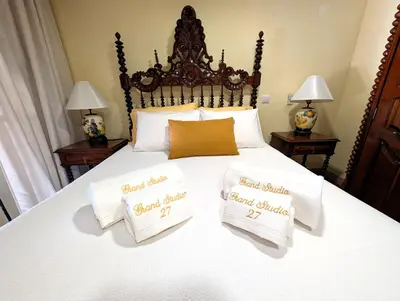 a bed with two pillows on top of it at Grand Studio 27 in Faro