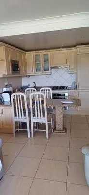 a kitchen with a table and four chairs in it at AA Apartamento Solar dos Pinheiros in Vilamoura